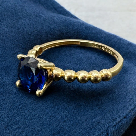ANILLO CON PIEDRA AZUL Y CONTORNO DE BOLITAS EN ORO MEXICANO 10 K