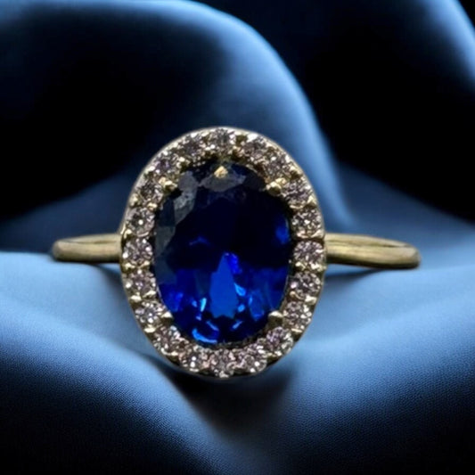 ANILLO CON UNA PIEDRA OVALADA AZUL EN ORO MEXICANO 10 K